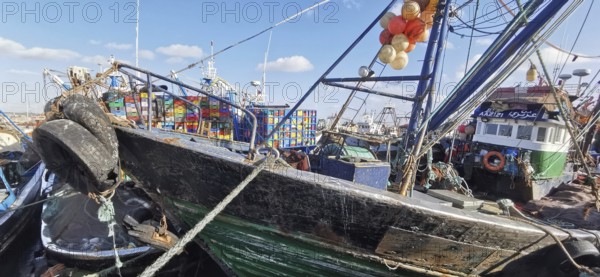 Close-up view of fishing boats with nets and colorful boxes in the harbor, Essaouira, Morocco