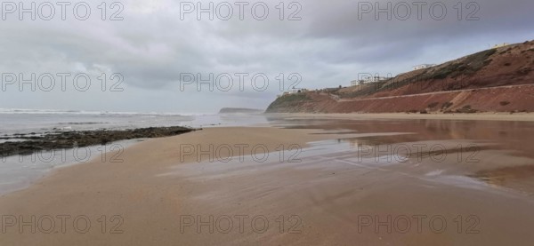 Extensive beach with calm sea and cloudy sky, Morocco