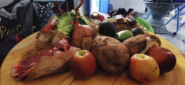 Various foods on wooden table, including fruit, vegetables and meat, Morocco
