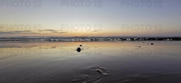 Evening on the beach with soft waves and peaceful horizon, Morocco