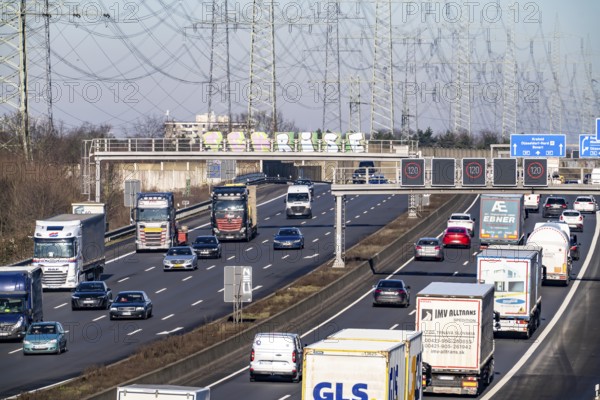 A57 motorway near Kaarst in the Rhein-Kreis Neuss, view towards Kaarst motorway junction, heavy traffic, overhead line, high-voltage lines, along the motorway, North Rhine-Westphalia, Germany