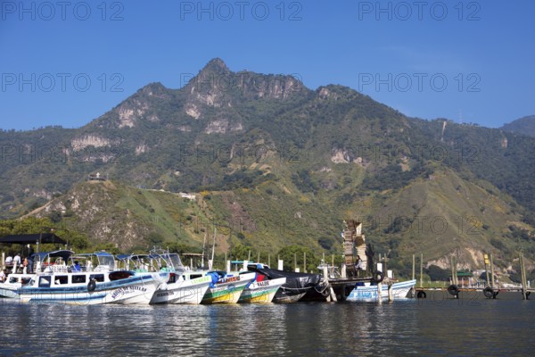 Colourful boats in the port of San Juan la Laguna, the mountains behind, Atitlán, Sololá Department, Guatemala