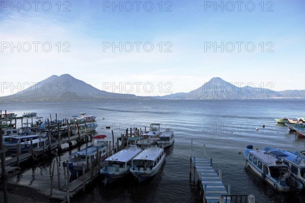 Boats on the pier, Lake Atitlán or Lake Atitlán in the morning, the volcanoes San Pedro, Atitlán and Toliman in the back, Panajachel, Sololá Department, Guatemala