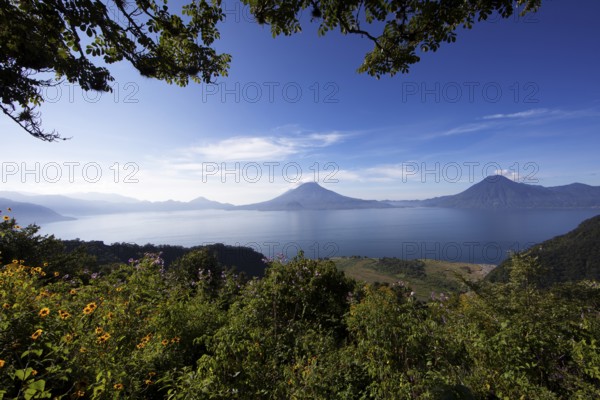 Lake Atitlán or Lake Atitlán in the morning, in the back the volcanoes San Pedro, Atitlán and Toliman, Panajachel, Sololá Department, Guatemala