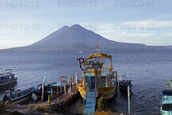 Boats on the dock, Lake Atitlán or Lake Atitlán in the morning, the volcanoes Atitlán and Toliman in the back, Panajachel, Sololá Department, Guatemala