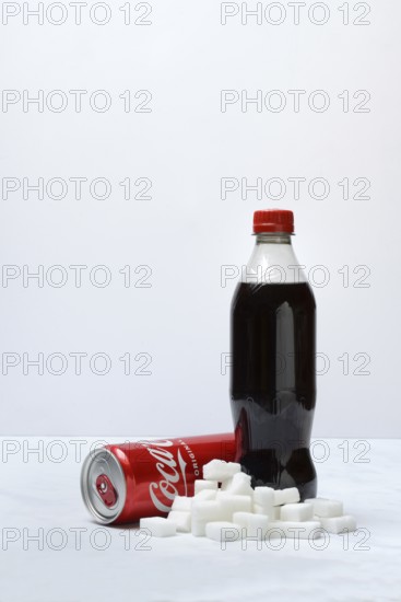 Cola drink in bottle and can, lots of sugar cubes
