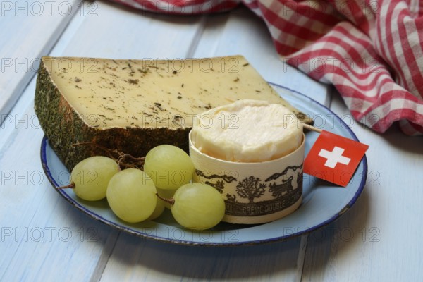 Plate of Swiss cheese, Gstaad mountain cheese with herbs and cream cheese 'Fette Berta', Switzerland