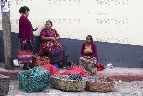 Mayan woman wearing traditional clothing sell chickens on the street in Chichicastenango, Highlands, El Quiché Department, Guatemala
