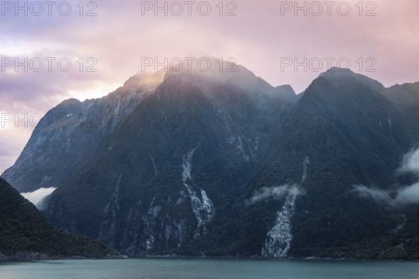 Panoramic view of scenic landscape of Milford Sound fjords in New Zealand at sunset