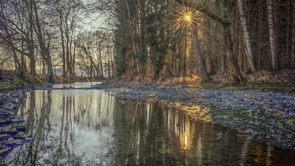 Romantic river landscape at sunset with rays of light through the trees and a peaceful atmosphere, Upper Franconia, Germany