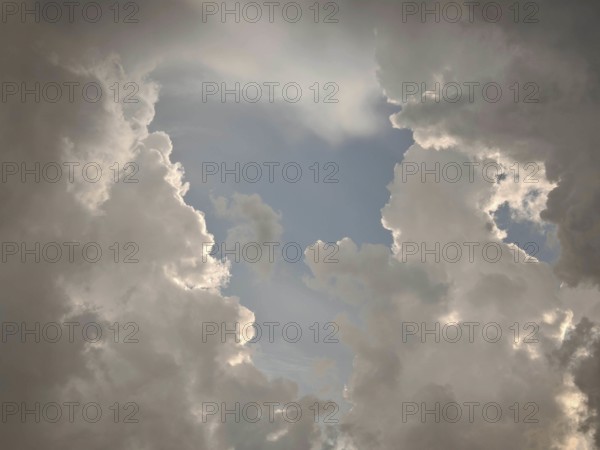 Dramatic cloud formations in the sky allow light to shine through, Germany