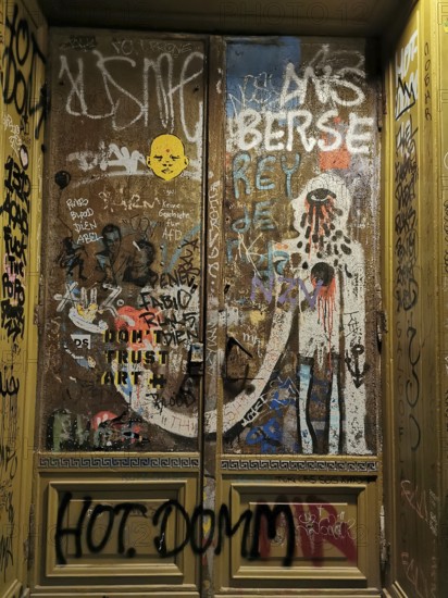 Graffiti-covered door full of tags and colorful colors that show urban art and creative self-expression