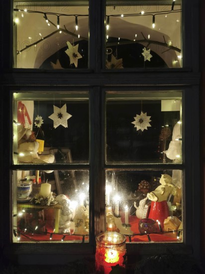 A Christmassy decorated window with atmospheric lighting and garland of lights, Franconian Forest