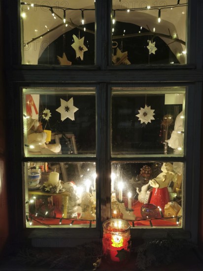 A festively decorated window with lights and Christmas decorations in a cozy atmosphere, Franconian Forest
