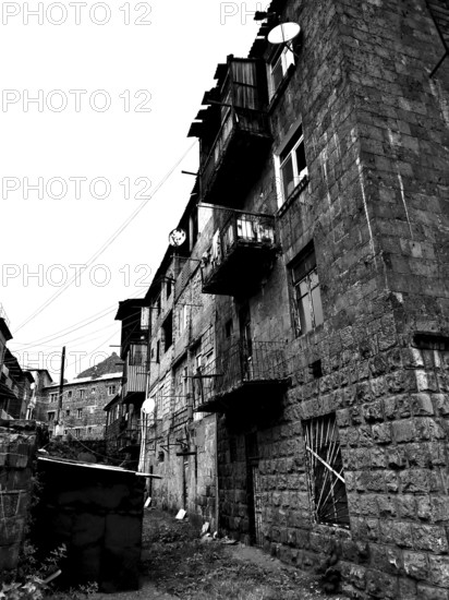 Abandoned street view with old, partly dilapidated buildings in a residential settlement, Alaverdi, Armenia