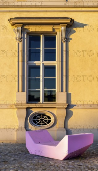 Pink and red plastic furniture for sitting and lying in front of the Humboldt Forum, Berlin, Germany