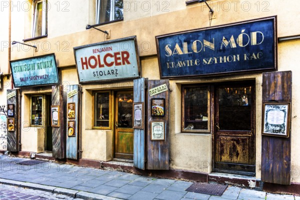 Shop fronts on Szeroka Street, signs bearing Polish and Jewish names, Kazimierz, a historically significant, formerly independent district that has developed into an important center of Jewish culture since the 14th century, Krakow, Poland