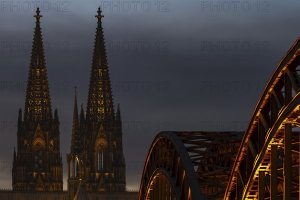 Evening atmosphere, Cologne Cathedral illuminated with LED lamps and the Hohenzollern Bridge, Cologne, North Rhine-Westphalia, Germany