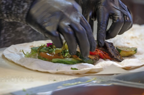 Preparation of falafel with fresh vegetables in a falafel stand in the pedestrian zone, Nuremberg, Middle Franconia, Bavaria, Germany