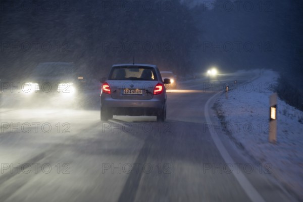 Car traffic in night snow flurries on B2, Heroldsberg, Middle Franconia, Bavaria, Germany