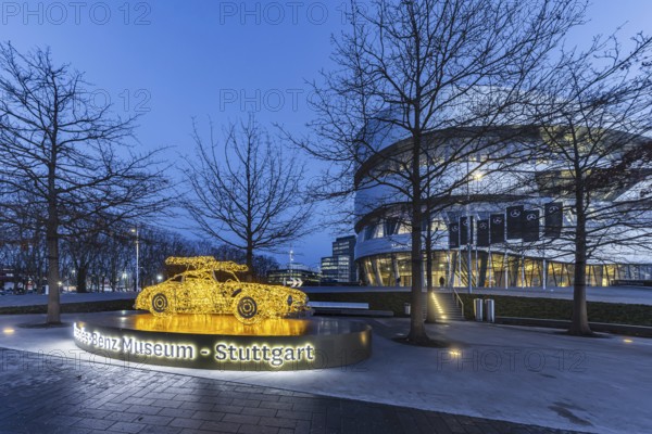 The Mercedes-Benz Museum in Stuttgart presents a journey through the automotive history of the global corporation. 160 vehicles are shown. At Christmas time, there is a light installation in front of the building. It represents the iconic classic Mercedes SL car. Night shot. Stuttgart, Baden-Württemberg, Germany