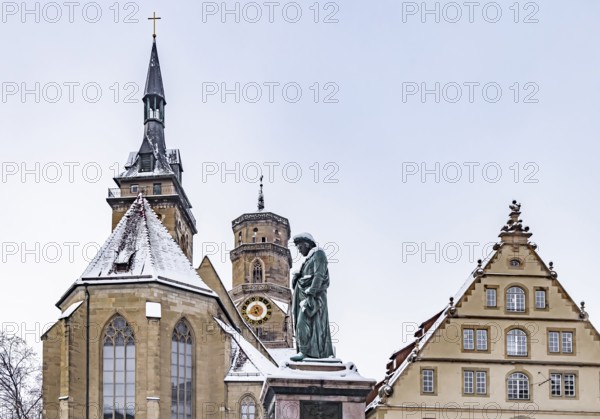 Winter in Stuttgart. The city is wintry white early in the morning. Schillerplatz with collegiate church, fruit box and Schiller monument. Stuttgart, Baden-Württemberg, Germany