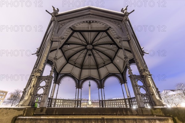 Winter in Stuttgart. It snowed overnight and the city is wintry white early in the morning. View of Schlossplatz and the New Palace through the bandstand. Stuttgart, Baden-Württemberg, Germany