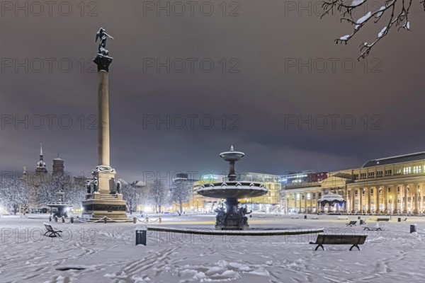 Winter in Stuttgart. It snowed overnight and the city is wintry white early in the morning. Palace Square with anniversary column, royal building and art museum. Stuttgart, Baden-Württemberg, Germany