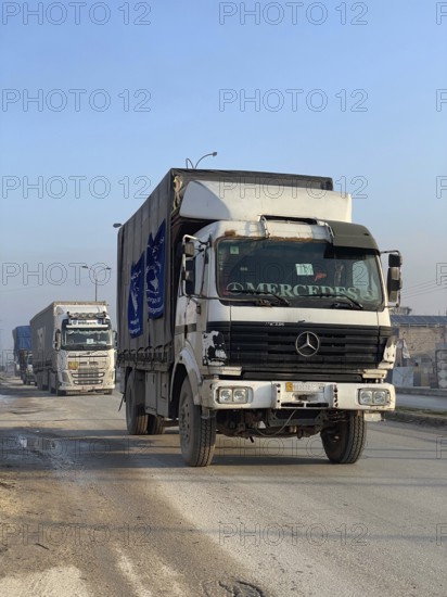 In Aleppo, Syria on January 25, 2026, a 24-vehicle humanitarian aid convoy, carrying UN relief items, departs for Ayn al-Arab. The mission follows a 15-day extension of the temporary ceasefire between the Syrian government and the YPG, Aleppo, Ayn al-Arab, Syria