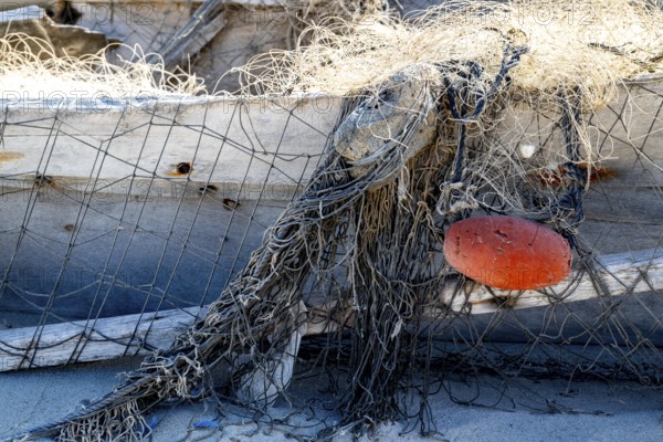 Close-up view of old fishing net hanging on boat, Oman