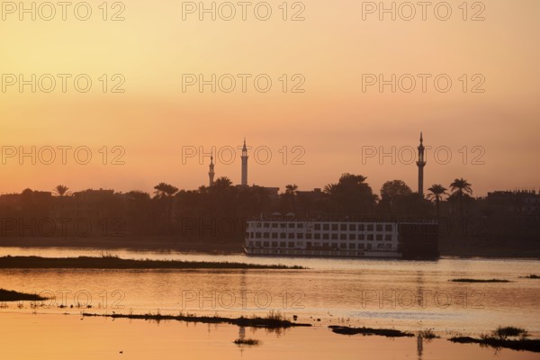 Nile cruise ship at sunset on the Nile, Luxor, Egypt