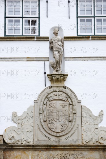 Torhaus am palace gardens, façade with figure and coat of arms, Husum, North Frisia, Schleswig-Holstein, Germany