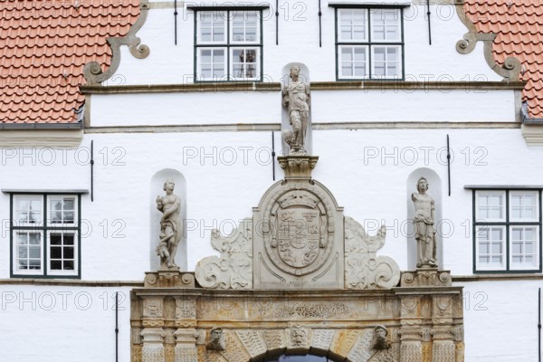 Torhaus am palace gardens, façade with figure and coat of arms, Husum, North Frisia, Schleswig-Holstein, Germany