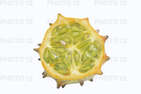 Horned cucumber, kiwano or horned melon (Cucumis metuliferus), sliced fruit on a white background, native to Africa
