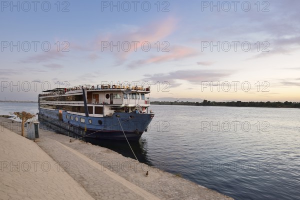 Nile cruise ship at a pier at dawn, Esna, Egypt