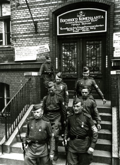 Two Soviet soldiers in front of the administration of the war commander for the district of Prenzlauer Berg, June 1945, Berlin, Germany