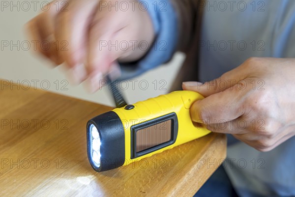 Crank operated flashlight, by turning the crank, we generate electricity in a dynamo, which charges a battery in the flashlight, in addition a small solar module to generate electricity from sunlight, for emergency preparedness in the event of a power failure, blackout, energy supply