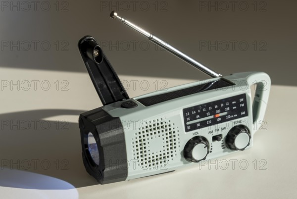 Radio with crank mode, by turning the crank we generate electricity in a dynamo, which charges a battery in a flashlight, in addition a small solar module to generate electricity from sunlight, for emergency preparedness in the event of a power failure, blackout, energy supply