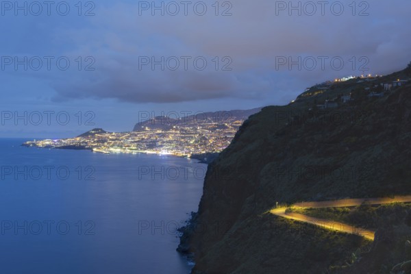 View of the Atlantic Ocean from Christo Rei viewpoint at dusk, harbour with cruise ships and Funchal, Madeira, Portugal