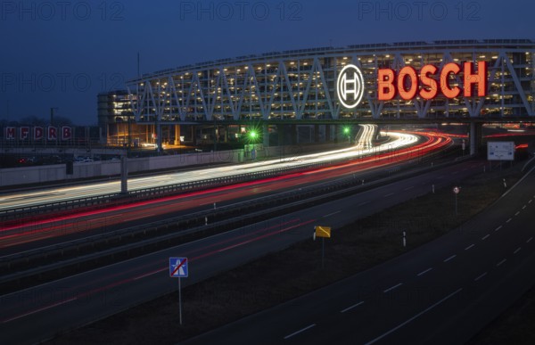 Traffic on the A8 motorway, blue hour, illuminated parking garage, Landesmesse Stuttgart, red-lit Bosch logo, second-largest logo in the world 55 meters wide, Baden-Württemberg, Germany