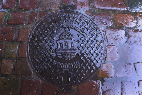 Manhole cover with the coat of arms of Krakow, Krakow, Poland