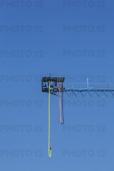 Montreal Bungee Tower installation with dangling long yellow elastic bungee jumping cord, Old Port of Montreal, Quebec, Canada