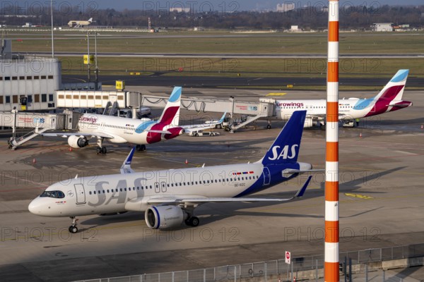 Düsseldorf Airport, DUS, Terminal A Eurowings plane at the gate, SAS plane after landing