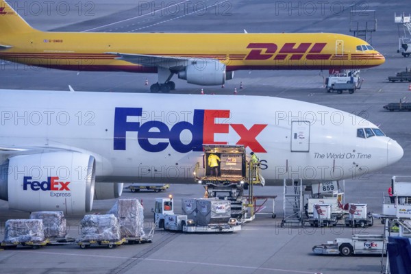 FedEx Express Boeing 777-FS2 cargo aircraft air freight containers are unloaded, DHL Boeing 757-200 at the air freight center at Cologne/Bonn airport, North Rhine-Westphalia, Germany