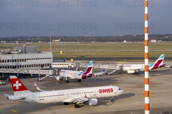 Düsseldorf airport, DUS, terminal A Eurowings aircraft at the gate, Swiss Airbus A321-200 aircraft on their way to takeoff