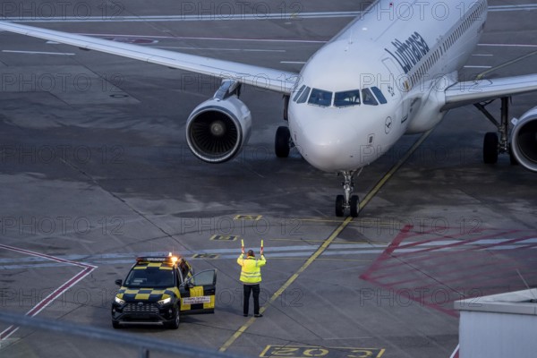 Apron supervision, Lufthansa Airbus is instructed to the parking position at the gate, at Cologne/Bonn Airport, North Rhine-Westphalia, Germany