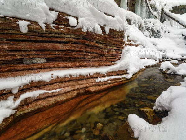 Taugl or Tauglbach flows through the snow-covered and icy red gorge, also Marmorklamm, Bad Vigaun, Tennengau, Salzburg, Austria