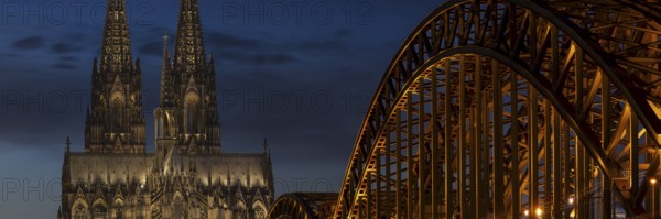 Evening atmosphere, Cologne Cathedral illuminated with LED lamps and the Hohenzollern Bridge, Cologne, North Rhine-Westphalia, Germany
