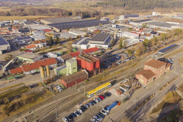 Aerial view of an industrial landscape with yellow train and various buildings, acceptance of the Hermann Hesse Railway, Weil der Stadt, Black Forest, Germany