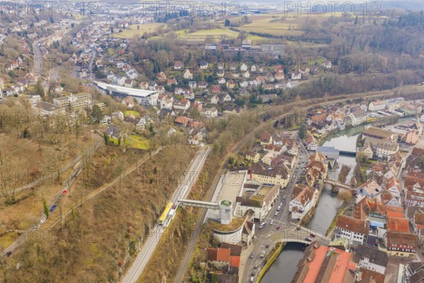 Panoramic picture of a city with river and railroad tracks, surrounded by wooded hills, acceptance of the Hermann Hesse Railway, Calw, Black Forest, Germany